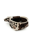 cowhide print bag on a white background