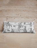 Decorative pillow with black and white pattern on a wooden surface