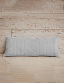 Striped pillow on a wooden surface