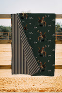 Fabric with cowboy pattern and stripes on a wooden surface