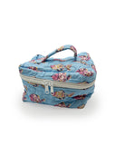 Floral-patterned fabric travel bag on a white background