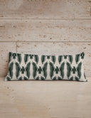 Decorative pillow with a black and white pattern on a wooden surface