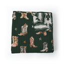 Green quilt with cowboy boot and western pattern on a white background