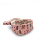 Pink travel bag with boot print on a white background