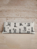 Pillow with cowboy boot pattern on a wooden surface