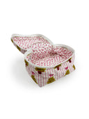 open top of pink and white striped quilted travel case with green christmas tree, pink bow, and red pot